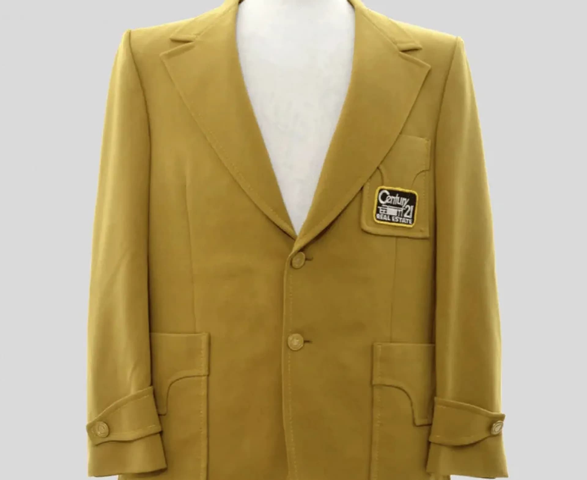 Das ikonische goldene CENTURY 21 Sakko